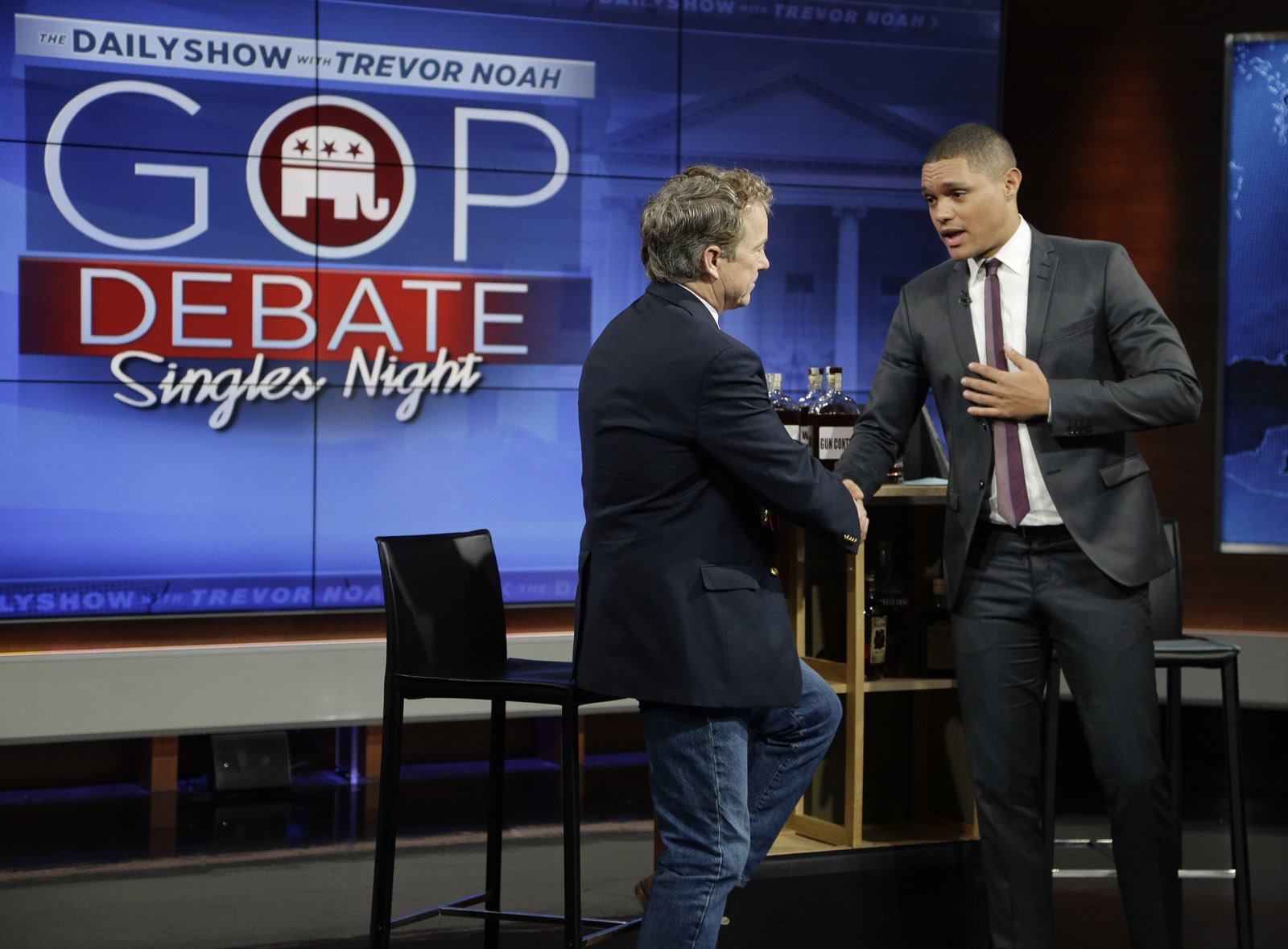 Republican presidential candidate, Sen. Rand Paul, R-Ky., left, talks with Trevor Noah after taping a segment of the "The Daily Show with Trevor Noah," Wednesday, Jan. 13, 2016, in New York. After recent polls in Iowa and New Hampshire left him out of Thursday's prime-time presidential debate on the Fox Business Network, Paul has asked Republican Party leaders to include him in the main stage debate, using the results of a new poll in Iowa as leverage. (AP Photo/Julie Jacobson)