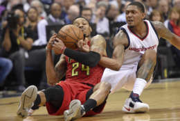 Washington Wizards guard Bradley Beal, right, battles for the ball against Atlanta Hawks forward Kent Bazemore (24) during the first half in Game 5 of a first-round NBA basketball playoff series, Wednesday, April 26, 2017, in Washington. (AP Photo/Nick Wass)