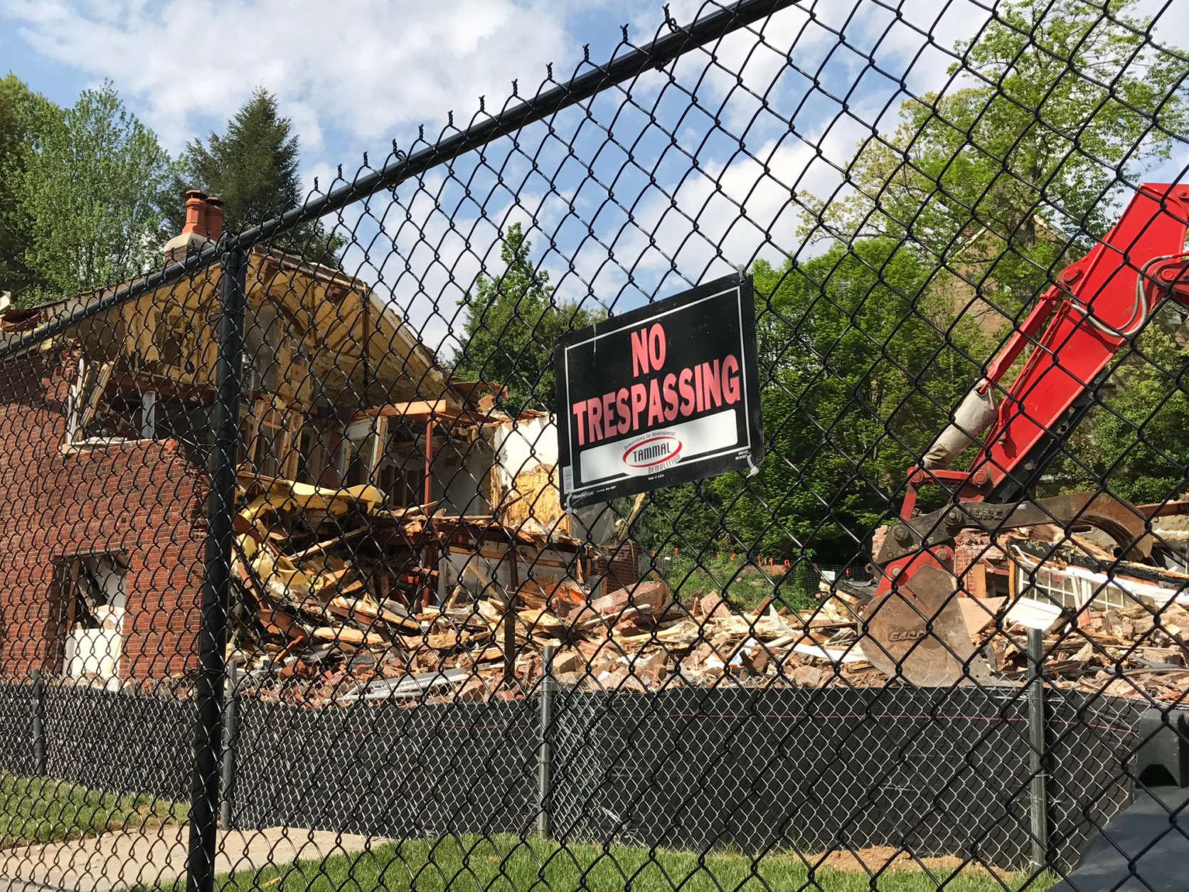 Construction crews begin to tear down a posh D.C. house that was the scene of a 2015 quadruple homicide on Friday, April 21, 2017. The house sold for $3 million months after Savvas and Amy Savopoulos, their son Philip and housekeeper Vera Figueroa were killed. (WTOP/Megan Cloherty)