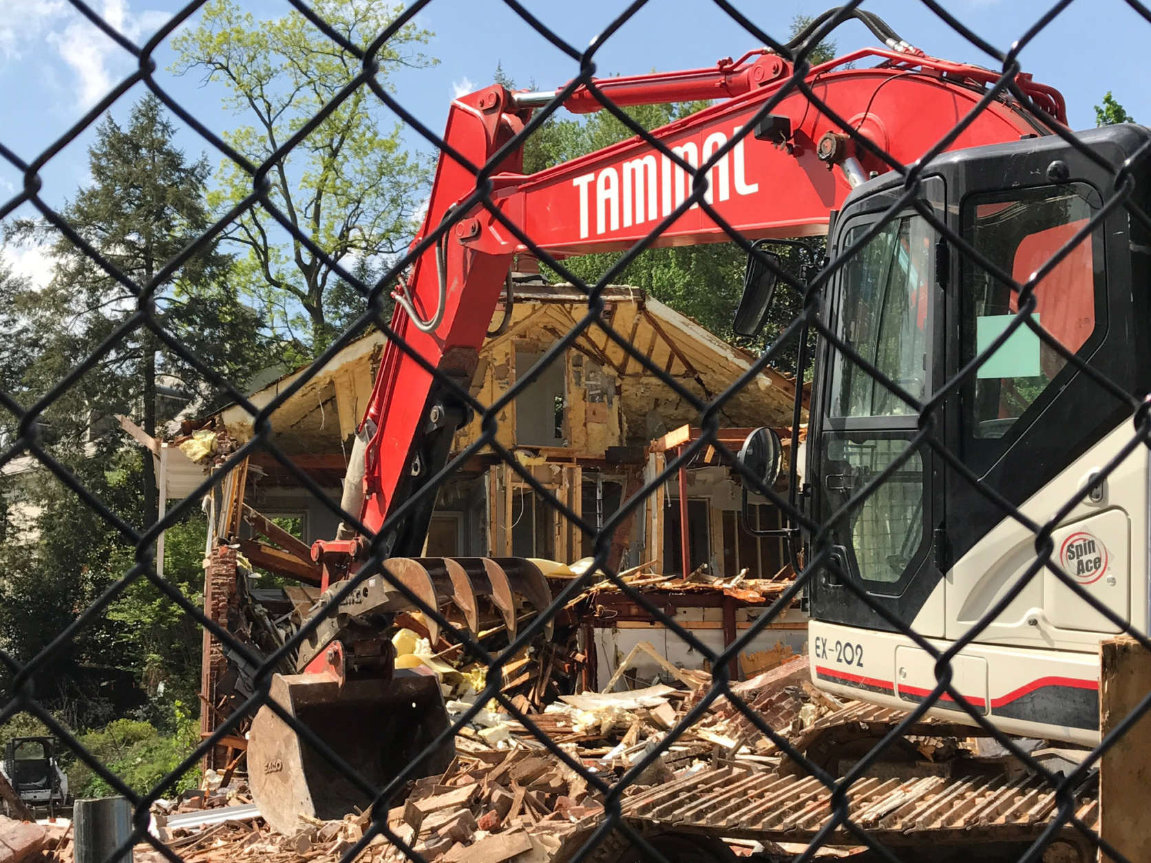 Construction crews tear down a posh D.C. house that was the scene of a 2015 quadruple homicide on Friday, April 21, 2017. The house sold for $3 million months after Savvas and Amy Savopoulos, their son Philip and housekeeper Vera Figueroa were killed. (WTOP/Megan Cloherty)