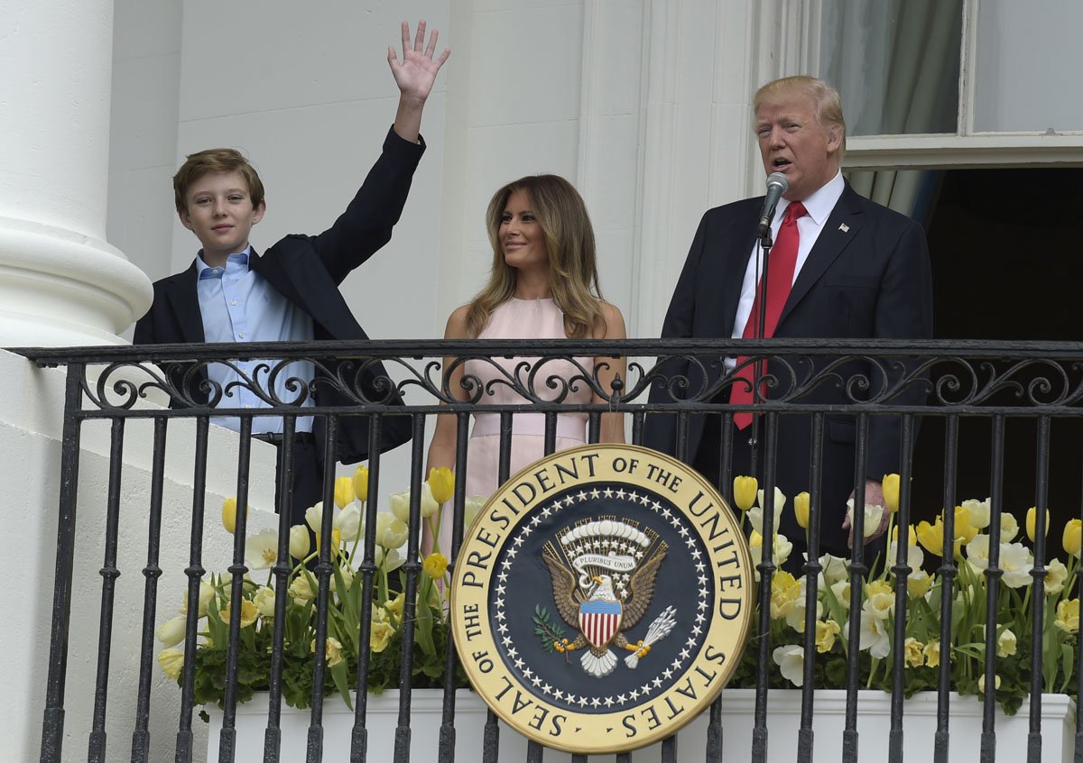 In this April 17, 2017, file photo, President Donald Trump, accompanied by first Lady Melania Trump, introduces their son Barron Trump from the Truman Balcony of the White House in Washington.  (AP Photo/Susan Walsh, File)