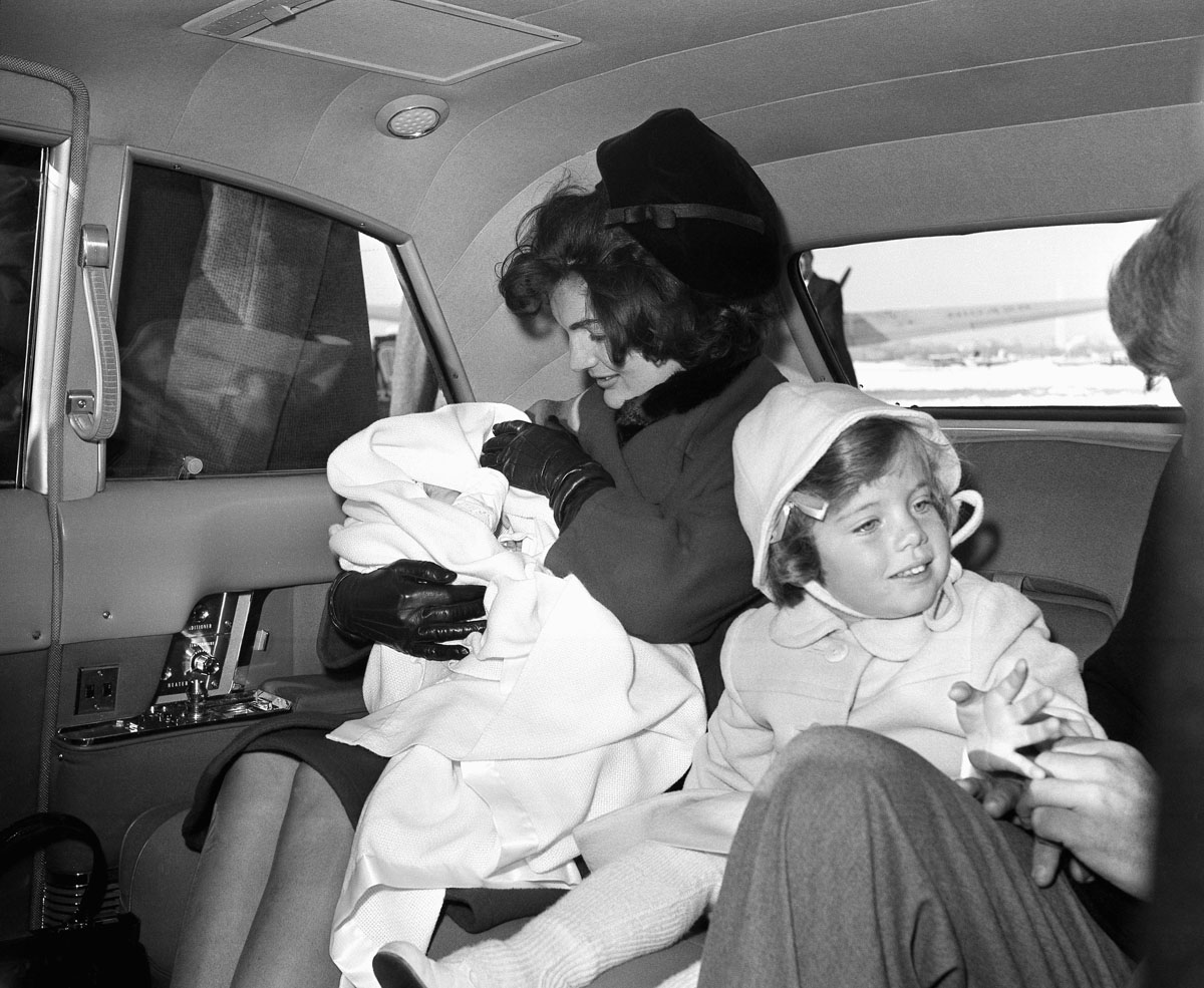 Caroline Kennedy, seen here in Feb. 1961 alongside her mother Jacqueline Kennedy, in a limousine at Washington National Airport, attended first grade in a special classroom set up on the third floor of the White House. (AP photo)
