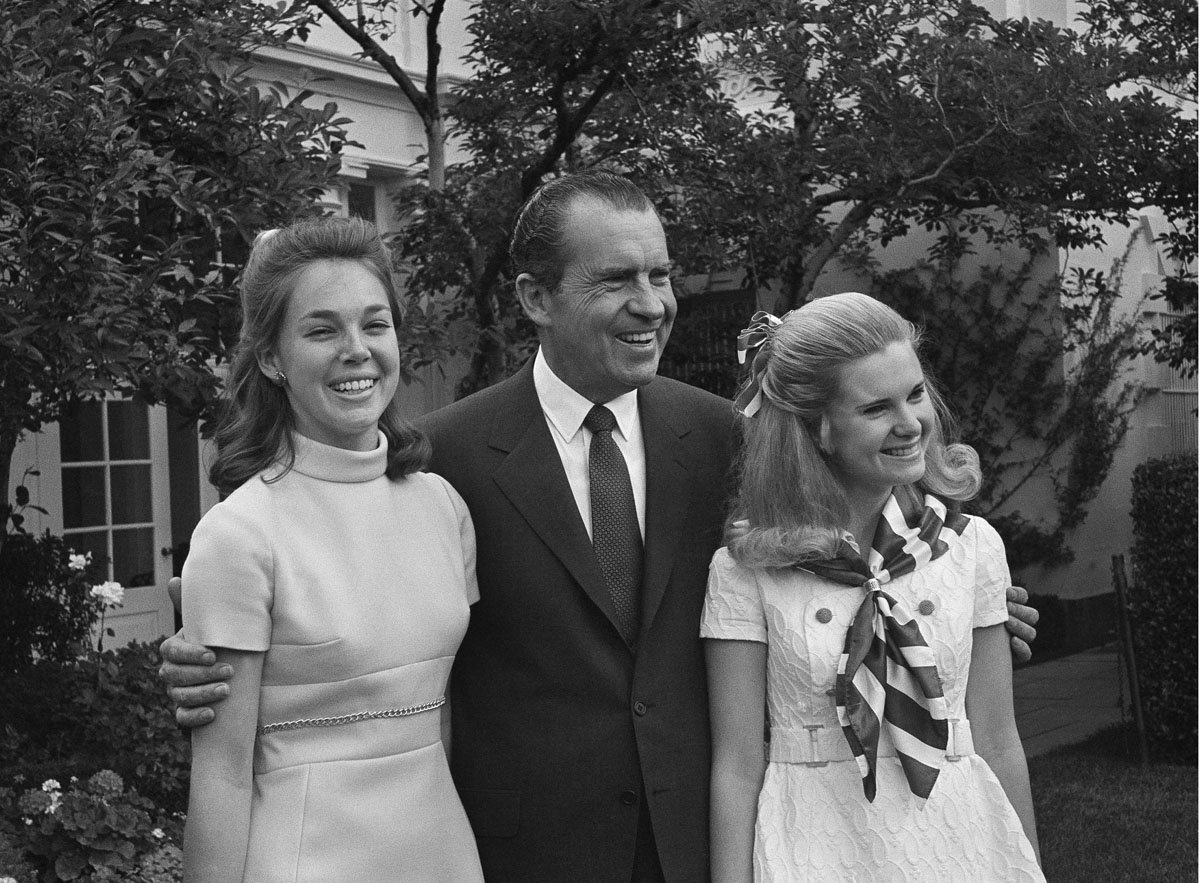 Julie Nixon Eisenhower, left, and Tricia Nixon, right, pose with their father President Richard Nixon in June 1969 at the White House. Both daughters earlier attended Sidwell Friends. (AP Photo/John Rous)