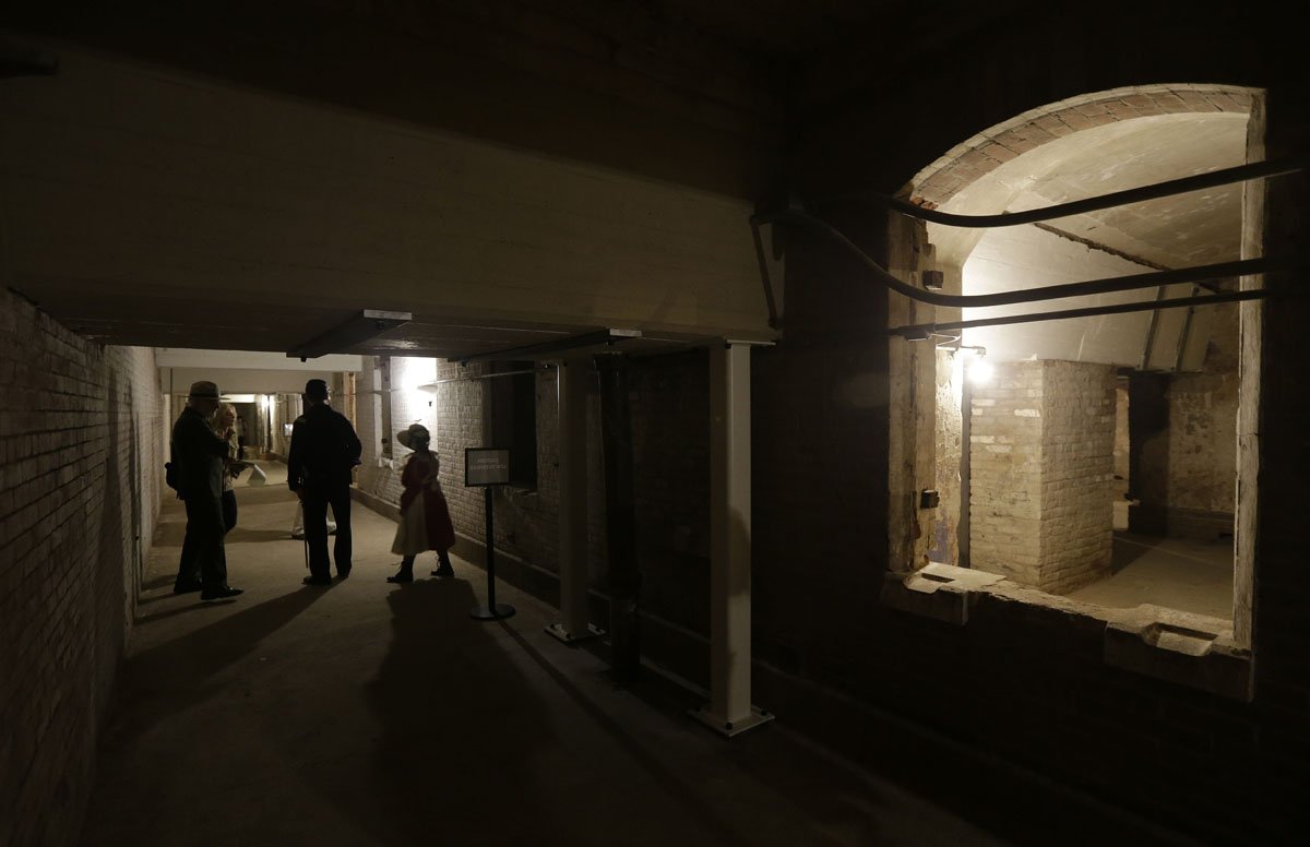 Media and guests walk through the citadel, also known as the the dungeon, during a tour of newly restored areas on Alcatraz Island Wednesday, July 1, 2015, in San Francisco. The National Park Service pulled the tarps off upgrades at Alcatraz Island after $3 million in improvements to the guardhouse, the citadel and other historic features. The park service on Wednesday unveiled the results of more than a year of work. (AP Photo/Eric Risberg)