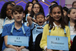 David Lye of Olathe, Kansas, center, flanked by Sam Fetters of West Tisbury, Mass., left, and Simone Kaplan of Davie, Fla., yawns during the opening round of the 90th Scripps National Spelling Bee in Oxon Hill, Md., Wednesday, May 31, 2017.  (AP Photo/Jacquelyn Martin)