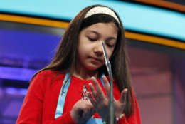 Melodie Loya, 12, from Bainbridge, N.Y., uses her hand as and imaginary paper and pen to spell her word during the finals of the 90th Scripps National Spelling Bee, Thursday, June 1, 2017, in Oxon Hill, Md. (AP Photo/Alex Brandon)