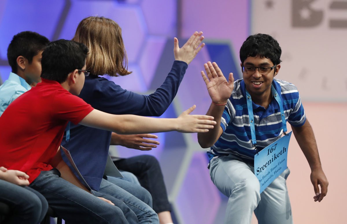 Sreeniketh Vogoti, 14, from Saint Johns, Fla., right, celebrates with his fellow spellers after spelling his word correctly during the 90th Scripps National Spelling Bee, Thursday, June 1, 2017, in Oxon Hill, Md. (AP Photo/Alex Brandon)