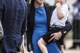 Kate, the Duchess of Cambridge, reacts to a low flying air display as she carries Prince George during a visit to the Royal International Air Tattoo at RAF Fairford in Gloucestershire, England, Friday July 8, 2016. (Richard Pohle/ Pool photo via AP)