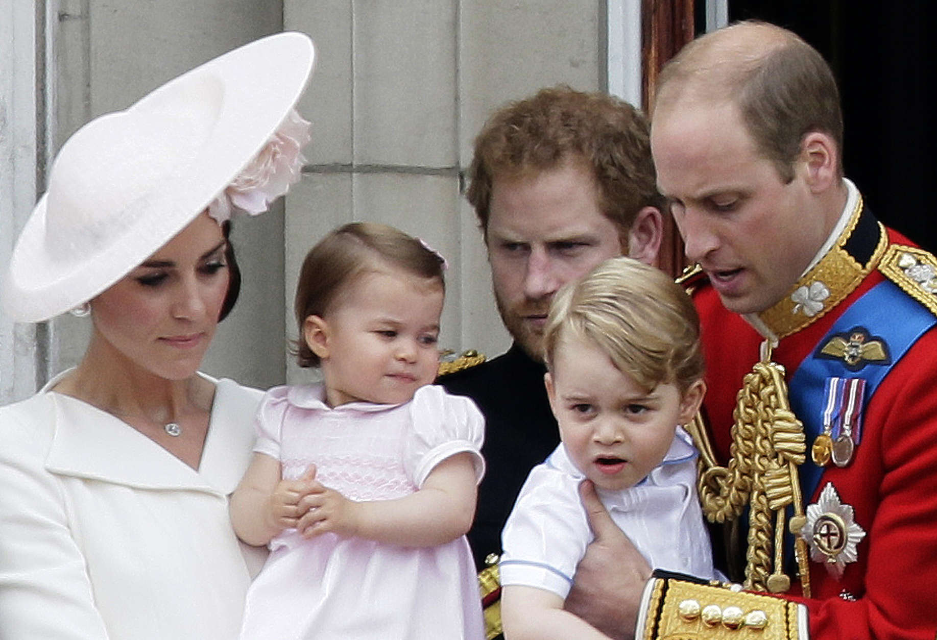 Britain's Prince William holding Prince George, right and Kate, Duchess of Cambridge holding Princess Charlotte, left, on the balcony during the Trooping The Colour parade at Buckingham Palace, in London. (AP Photo/Tim Ireland, File)