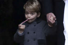 In this Sunday, Dec. 25, 2016 file photo, Prince George eats a sweet as he leaves following the morning Christmas Day service at St Mark's Church in Englefield, England. (Andrew Matthews/Pool via AP, File)