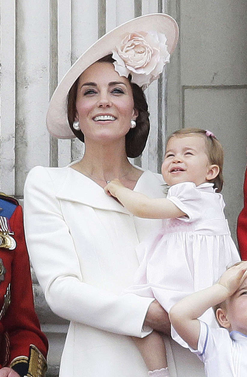 In this Saturday, June 11, 2016 file photo, Britain's Kate, Duchess of Cambridge, holding Princess Charlotte on the balcony during the Trooping The Colour parade at Buckingham Palace, in London. It's nearly party time for Britain's Princess Charlotte, who celebrates her 2nd birthday on Tuesday.  (AP Photo/Tim Ireland, File)