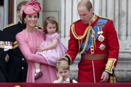 Kate, The Duchess of Cambridge, holds Princess Charlotte with Prince William at right and Prince George, foreground, on the balcony of Buckingham Palace, after attending the annual Trooping the Colour Ceremony in London, Saturday, June 17, 2017. (Yui Mok/PA via AP)