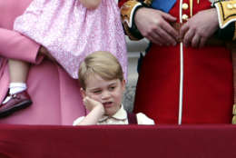 Britain's Prince George gestures,  as he stands on the balcony of Buckingham Palace with other members of the Royal family, after attending the annual Trooping the Colour Ceremony in London, Saturday, June 17, 2017. (Yui Mok/PA via AP)