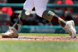 St. Louis Cardinals' Matt Carpenter wears camouflage socks as part of his Memorial Day uniform as he fouls a ball off his leg while batting during the first inning of a baseball game against the Los Angeles Dodgers Monday, May 29, 2017, in St. Louis. (AP Photo/Jeff Roberson)