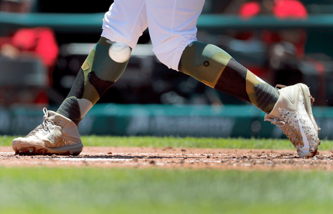 St. Louis Cardinals' Matt Carpenter wears camouflage socks as part of his Memorial Day uniform as he fouls a ball off his leg while batting during the first inning of a baseball game against the Los Angeles Dodgers Monday, May 29, 2017, in St. Louis. (AP Photo/Jeff Roberson)