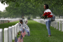 Angelica Danner and her daughter Liana lay roses at headstones in Arlington National Cemetery May 28, 2017 in Arlington, Virginia. Volunteers from throughout the country gather to place a rose on each grave in preparation for Memorial Day. (Photo by Aaron P. Bernstein/Getty Images)