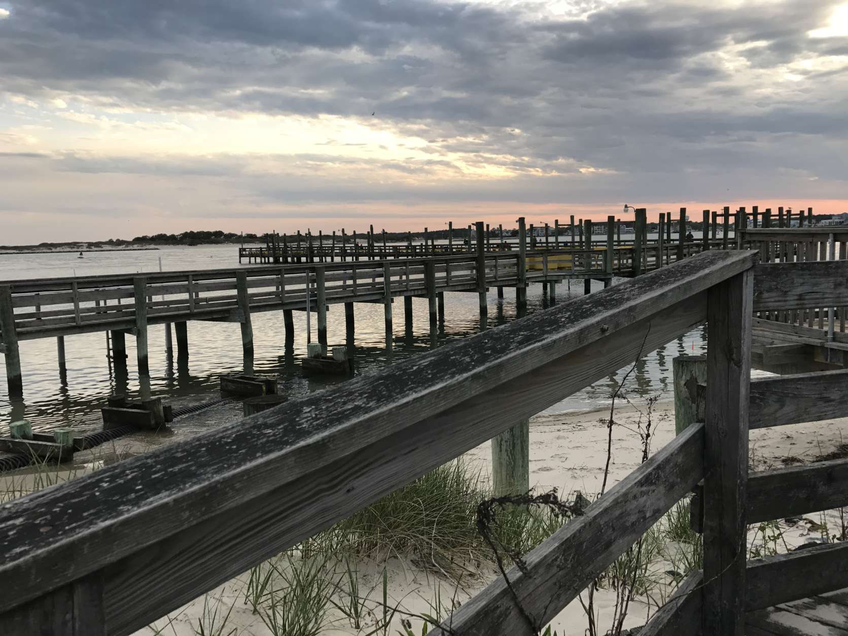 Sunset off the fishing piers in Ocean City, Maryland. (WTOP/Megan Cloherty) 