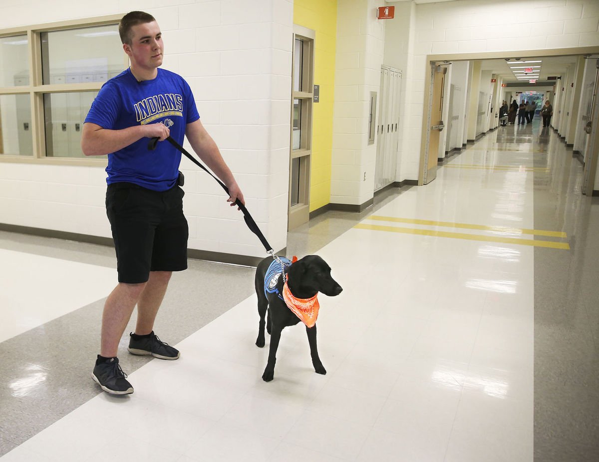 The black Labrador Retriever gives the 16-year-old his paw when his levels are too high or too low. (Courtesy Peter Cihelka/The Free Lance-Star) 
