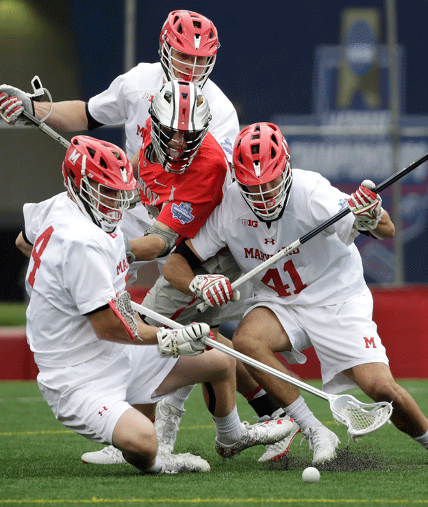 Ohio State's Freddy Freibott, center, is squeezed out by Maryland's Tim Muller, left, Bryce Young (41) and Curtis Corley, top, as they compete for the ball during the first half of the NCAA college Division 1 lacrosse championship final, Monday, May 29, 2017, in Foxborough, Mass. (AP Photo/Elise Amendola)