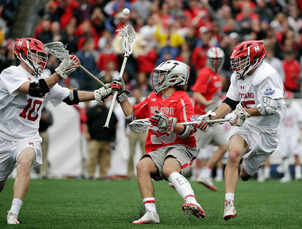Ohio State's Logan Maccani, middle, loses control of the ball under pressure from Maryland's Jared Bernhardt (10) and Dylan Maltz, right, during the first half of the NCAA college Division 1 lacrosse championship final, Monday, May 29, 2017, in Foxborough, Mass. (AP Photo/Elise Amendola)