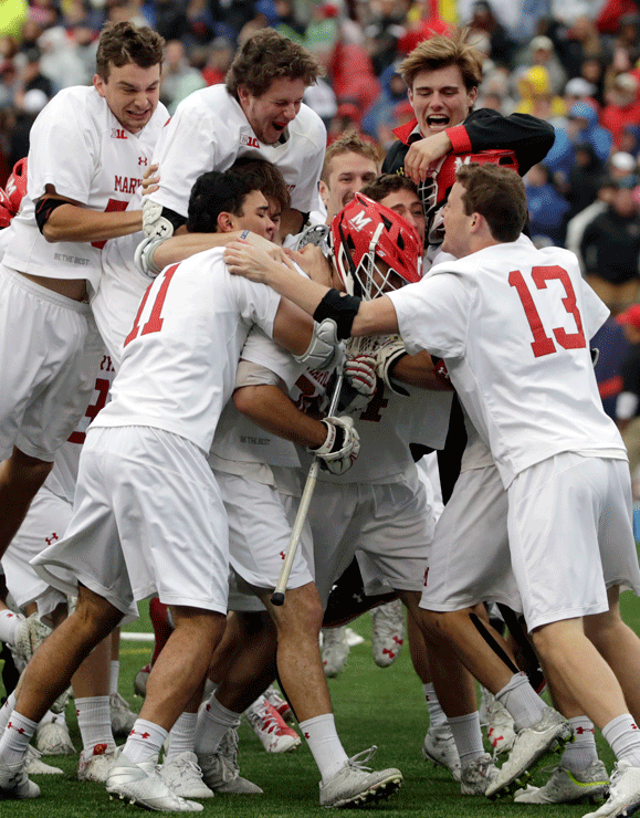 Maryland players jump on goalkeeper Dan Morris to celebrate their 9-6 victory over Ohio State in the NCAA college Division 1 lacrosse championship final, Monday, May 29, 2017, in Foxborough, Mass. (AP Photo/Elise Amendola)