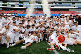 Maryland players gather around the trophy to celebrate after their victory over Ohio State in the NCAA college Division 1 lacrosse championship final, Monday, May 29, 2017, in Foxborough, Mass. (AP Photo/Elise Amendola)