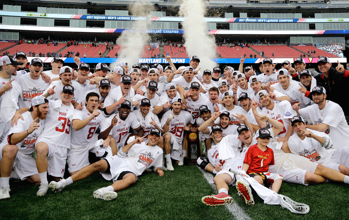 Maryland players gather around the trophy to celebrate after their victory over Ohio State in the NCAA college Division 1 lacrosse championship final, Monday, May 29, 2017, in Foxborough, Mass. (AP Photo/Elise Amendola)