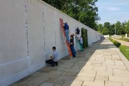 Photos of fallen American service members have been placed next to headstones and names on the Walls of the Missing at Cambridge American Cemetery as part of the Faces of Cambridge. (Courtesy American Battle Monuments Commission)