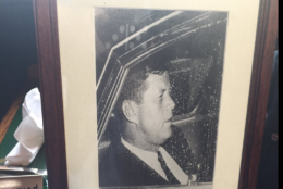 Kim Ciftci's mother took one photo of President Kennedy in Washington Circle as his motorcade slowly went by. It shows Kennedy apparently lost in thought behind a limousine window covered with raindrops. (WTOP/Michelle Basch)