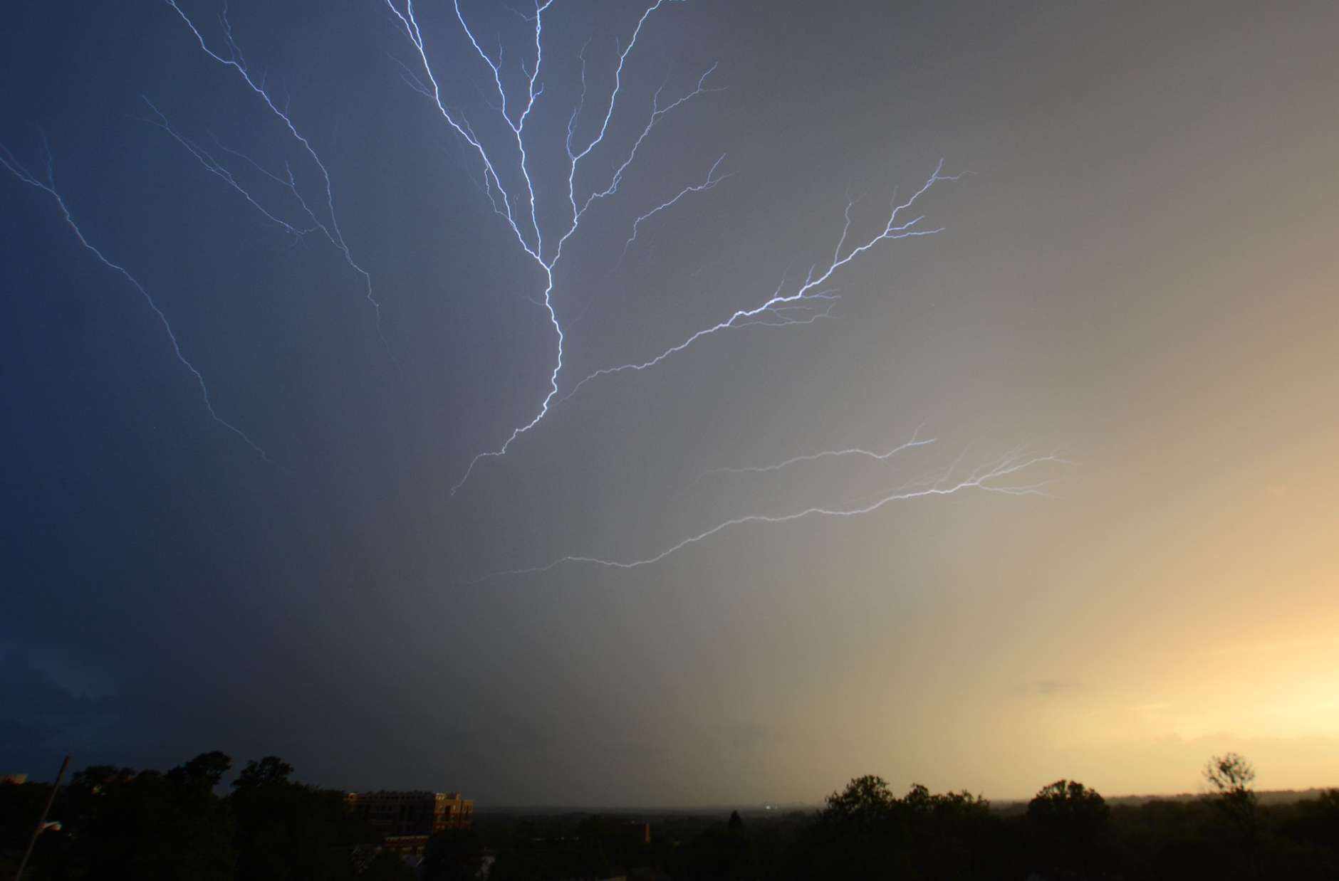 Day versus night, sun versus storm: An electric battle is waged above Washington Thursday night. (WTOP/Dave Dildine)
