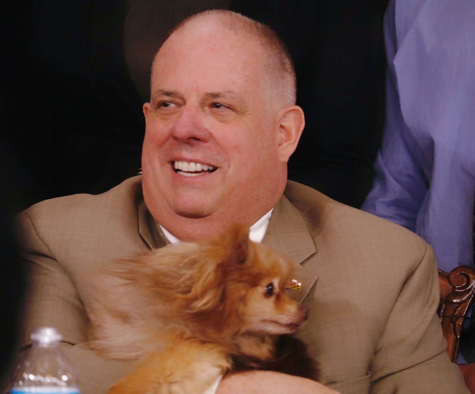 Maryland Gov. Larry Hogan holds one of the dogs from a Maryland animal welfare group before signing a number of bills designed to crack down on "the senseless crime of animal cruelty." Hogan, a dog- lover, asked about the backgrounds of many of the dogs. Lexi, Maryland's "First Dog," passed away in December. Hogan indicated he'd like to get another dog in the future. For now, he said of the presence of dogs at the bill-signing ceremony, "We should have dogs here every day!" (WTOP/Kate Ryan)