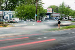 A man looks for a break in traffic to cross University Boulevard in Langley Park, Maryland. In the past eight years, at least 138 pedestrians have been hit and eight have died on a two-mile stretch of the state highway that runs through the low-income, immigrant community. (Capital News Service/Rebecca Rainey)