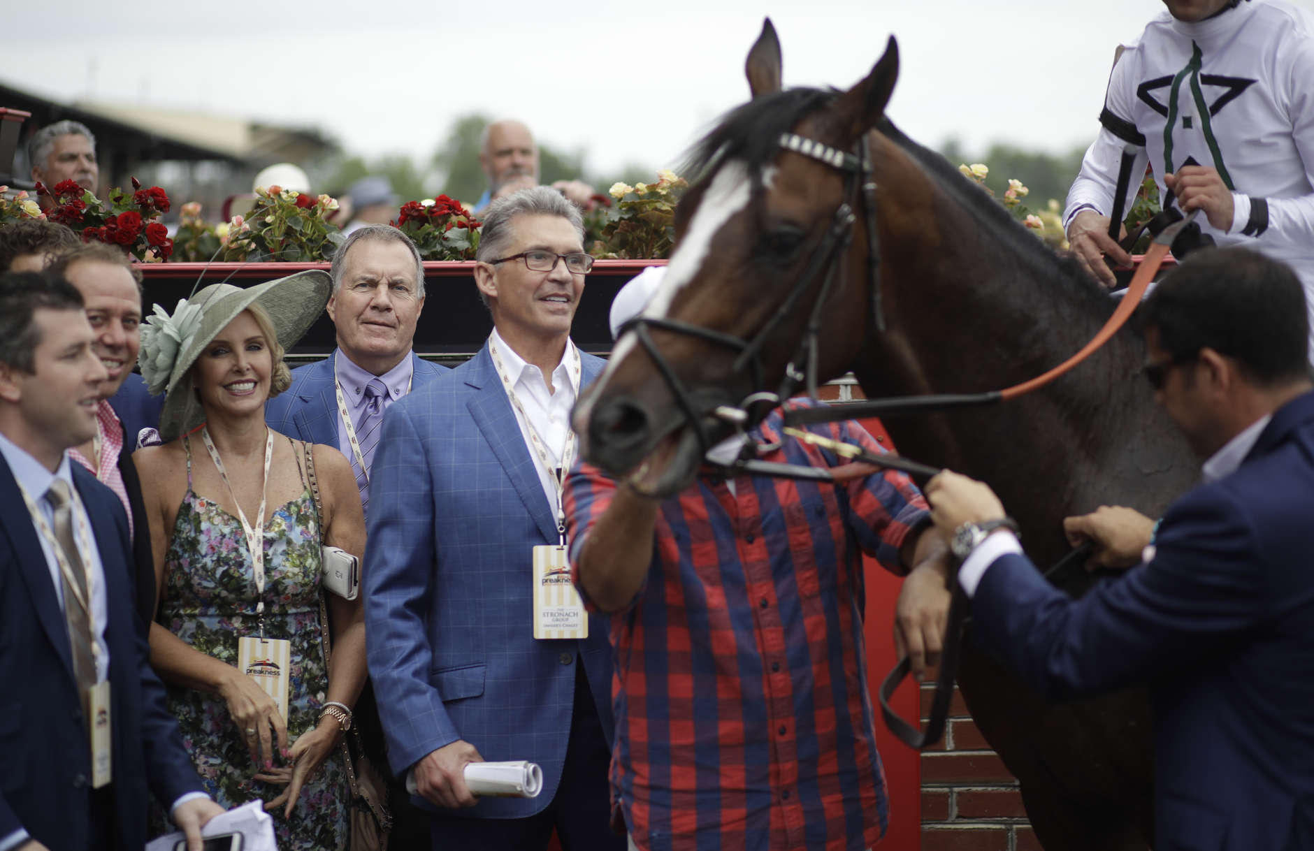 New England Patriots NFL football head coach Bill Belichick, second from right, speaks to race fans after race eight, ahead of the the running of the 142nd Preakness Stakes horse race at Pimlico race course, Saturday, May 20, 2017, in Baltimore. (AP Photo/Patrick Semansky)
