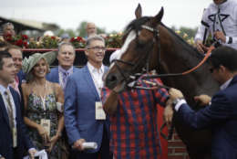 New England Patriots NFL football head coach Bill Belichick, second from right, speaks to race fans after race eight, ahead of the the running of the 142nd Preakness Stakes horse race at Pimlico race course, Saturday, May 20, 2017, in Baltimore. (AP Photo/Patrick Semansky)