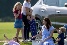 Britain's Kate, the Duchess of Cambridge, second right, sits with Prince George and Princess Charlotte as she talks to Autumn Phillips and her children, Savannah and Isla, as they watch Prince William take part in the Maserati Royal Charity Polo Trophy at the Beaufort Polo Club, in Tetbury, England, Sunday June 10, 2018. 