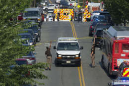 Police and emergency personnel are seen near the scene where House Majority Whip Steve Scalise of La. was shot during a Congressional baseball practice in Alexandria, Va., Wednesday, June 14, 2017.  (AP Photo/Cliff Owen)