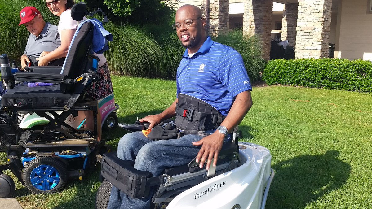 Jabari Wright in his Paramobile golf cart getting ready for fundraising tornament in Lansdowne, Virginia to help other vets. (WTOP/Kathy Stewart)