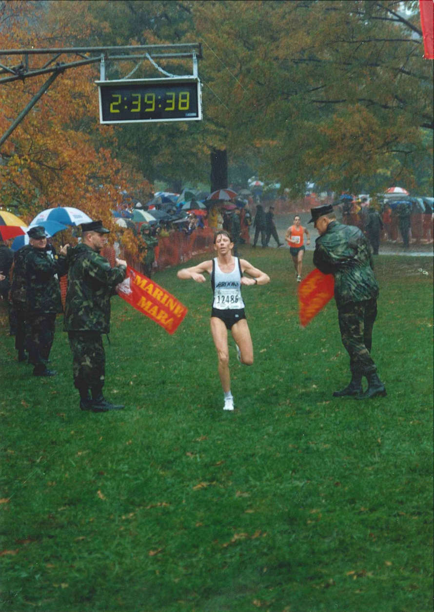 Donna Moore crosses the finish line of the 1997 Marine Corps Marathon as the first place female finisher. (Courtesy Marine Corps Marathon)
