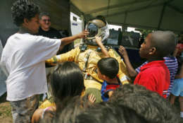 Children crowd around a space suit in the NASA section of the Smithsonian Folklife Festival  in Washington on Wednesday June 25, 2008. The festival runs through Sunday and again from July 2 to July 6. (AP Photo/Jacquelyn Martin)