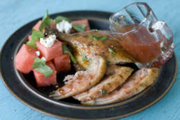 In this image taken on May 30, 2012, Elizabeth Karmel's grilled butterflied duck with spicy watermelon glaze is shown on a plate in Concord, N.H. (AP Photo/Matthew Mead)