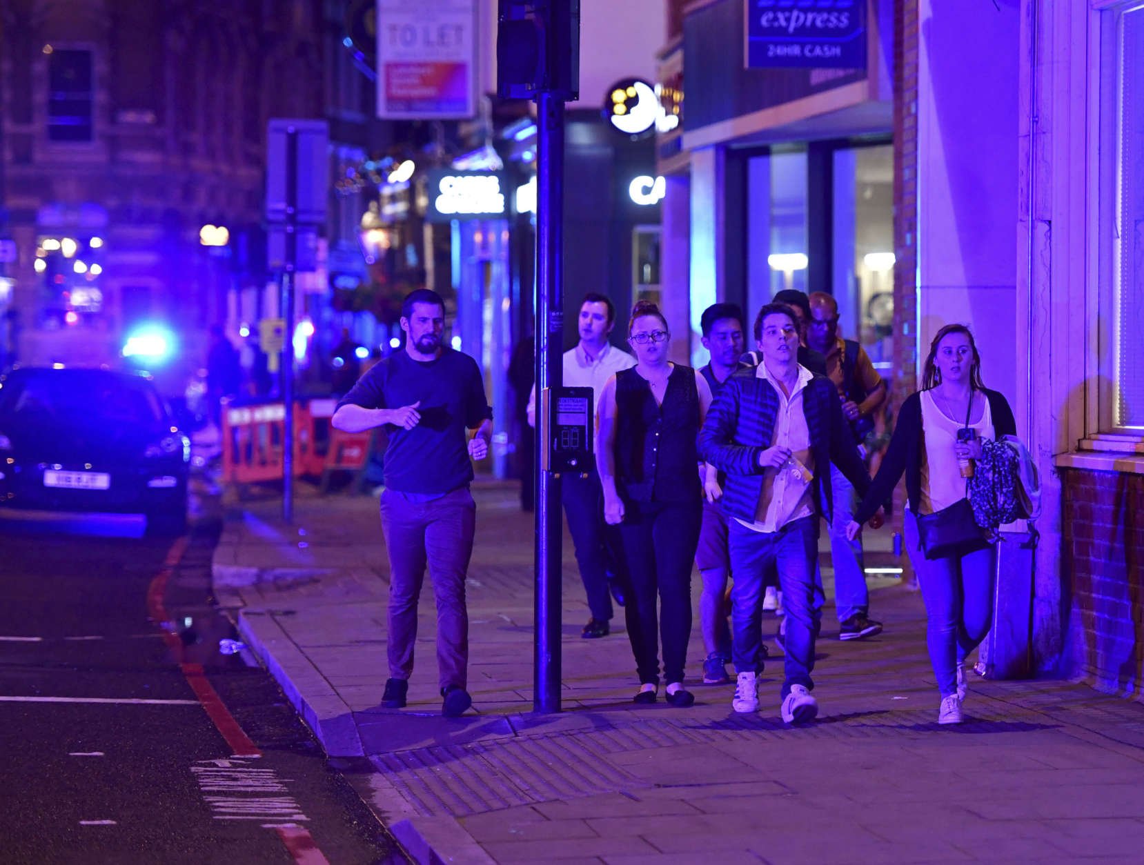 People run down Borough High Street as police are dealing with a "major incident" at London Bridge in London, Saturday, June 3, 2017. (Dominic Lipinski/PA via AP)