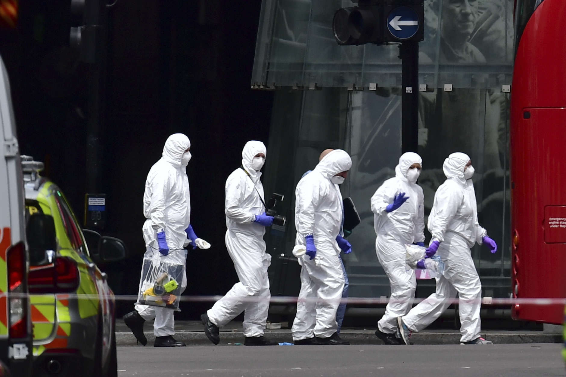 Police forensic officers outside Borough Market, London, Sunday June 4, 2017, near the scene of Saturday night's terrorist incident. Several people were killed in the incident and emergency officials said dozens were treated at London hospitals and a number of others suffered less serious injuries. (Dominic Lipinski/PA via AP)