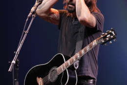 Dave Grohl, lead of the Foo Fighters band on stage following the introduction of new Apple products including the iPhone 5 in San Francisco, Wednesday, Sept. 12, 2012.  (AP Photo/Eric Risberg)