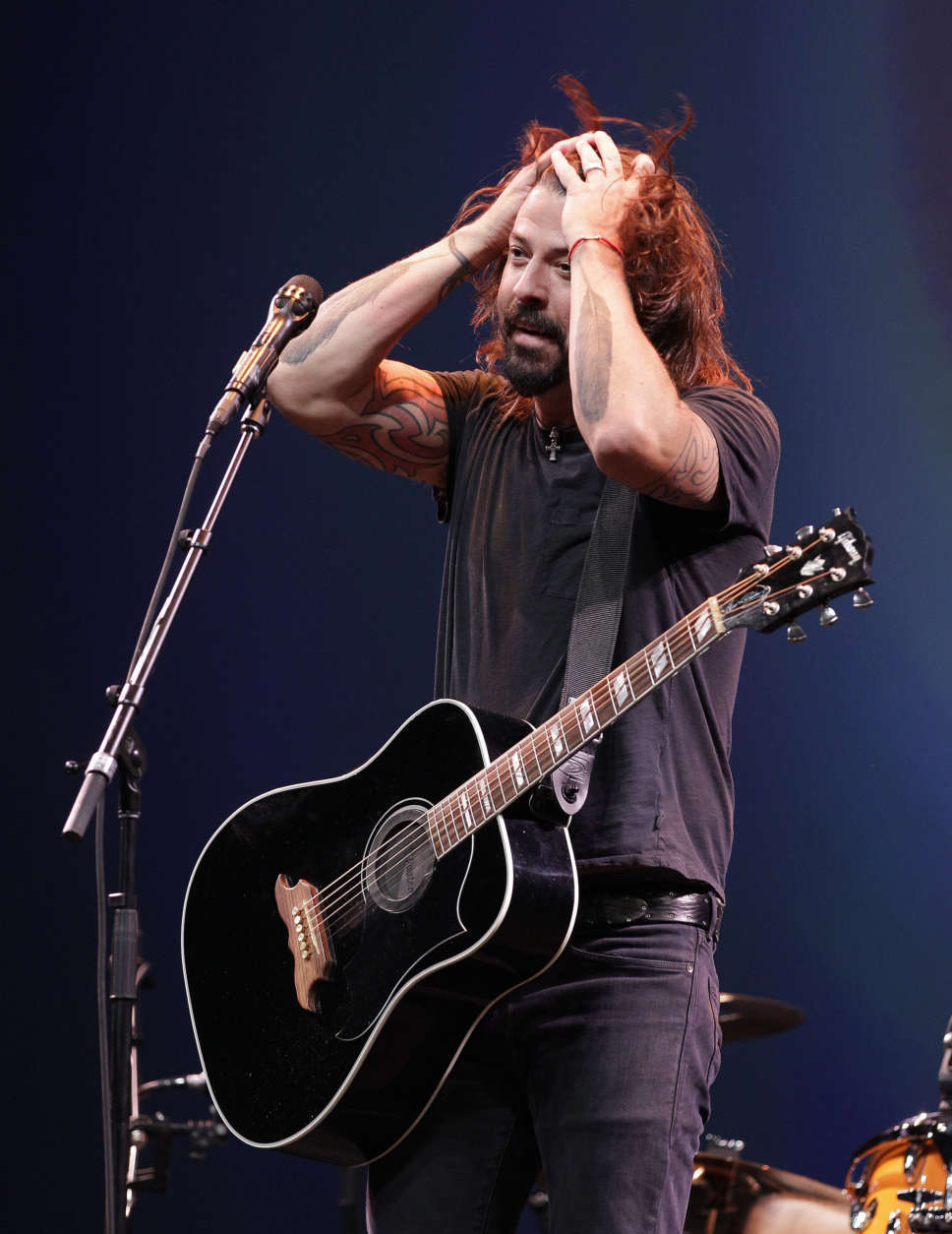 Dave Grohl, lead of the Foo Fighters band on stage following the introduction of new Apple products including the iPhone 5 in San Francisco, Wednesday, Sept. 12, 2012.  (AP Photo/Eric Risberg)