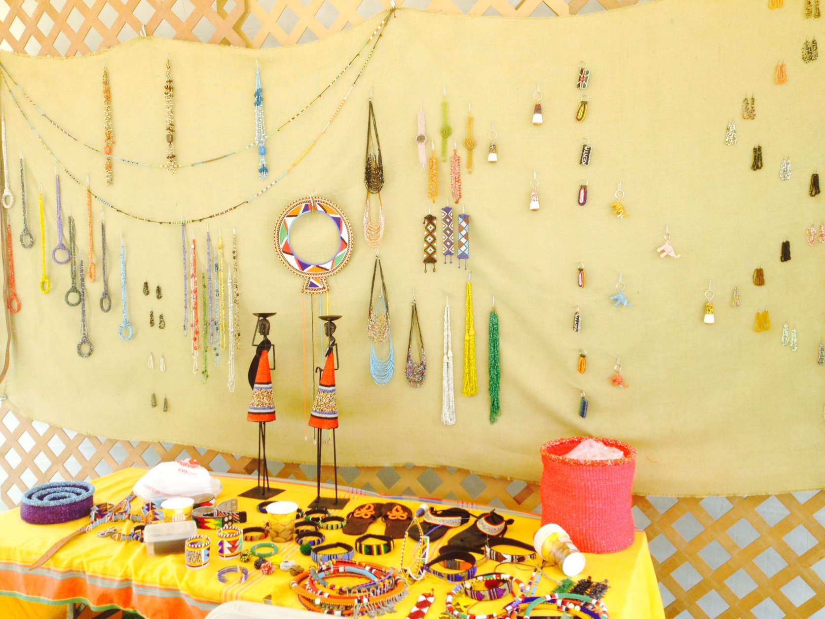This photo taken July 2, 2014 shows beds and jewelry displayed at the Kenya bead and jewelry making tent at the Smithsonian Folklife Festival on the National Mall in Washington. The Kenya: Mambo Poa exhibit brought the traditions of the East African country together in a cultural celebration. Beads have been integral to Africans for thousands of years. According to the Smithsonian Center for Education and Museum Studies website, the earliest examples of manufactured beads were found in in Libya and Sudan and date to 10,000 B.C. Bead work remains part of the cultural tradition in several African tribes, including Irungus Kikuyu, Chemakwanys Pokot and Caroline Sengenys Maasai. (AP Photo/Emmilyne Victor)