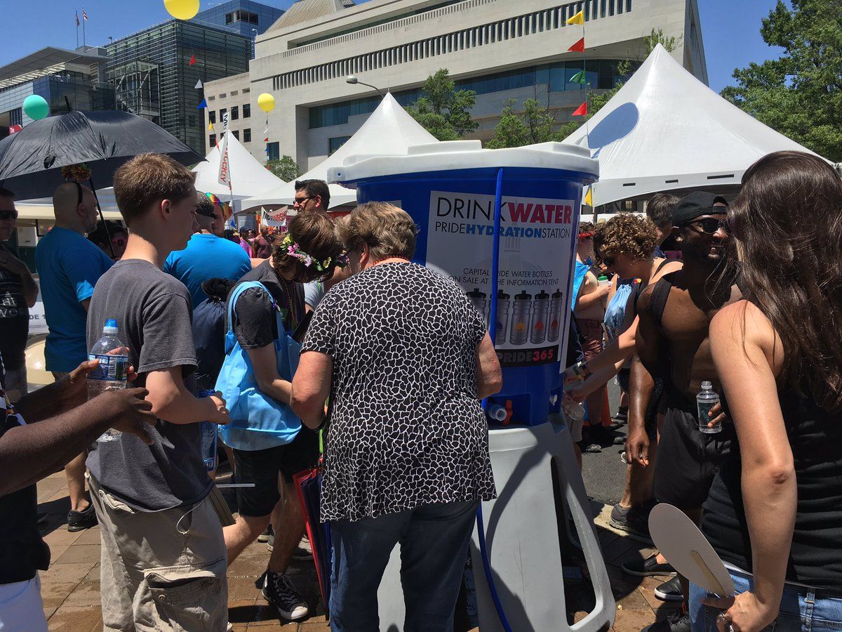 Attendees fill up on water during the D.C. Pride Festival on Sunday, June 11, 2017. (WTOP/Liz Anderson)