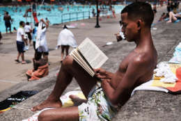 NEW YORK, NY - JUNE 29:  Emilo Moreno reads by the pool on a hot afternoon at the Astoria Pool in the borough of Queens on the opening day of city pools on June 29, 2016 in New York City.The main pool at Astoria, the biggest in New York City and administered by the New York City Department of Parks and Recreation, sees over 3,000 people on a typical summer weekday.  (Photo by Spencer Platt/Getty Images)