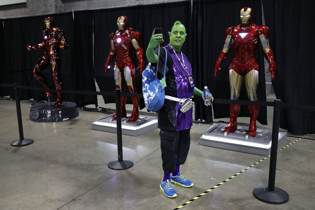 Mike Becvar of South Riding, VA, wears a Beast Boy costume while taking a selfie with lifesize Ironman models in the Stan Lee Museum exhibit during the first day of Awesome Con at the Walter E. Washington Convention Center June 16, 2017 in Washington, DC. Thousands of fans of popular culture, fantasy and science fiction will gather for the three-day convention that includes comic books, collectibles, toys, games, original art, cosplay and Marvel Comics legend Stan Lee.  (Photo by Chip Somodevilla/Getty Images)