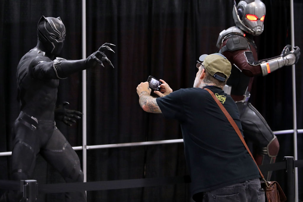 A man photographs the lifesize model of the Black Panther in the Stan Lee Museum exhibit during the first day of Awesome Con at the Walter E. Washington Convention Center June 16, 2017 in Washington, DC. Thousands of fans of popular culture, fantasy and science fiction will gather for the three-day convention that includes comic books, collectibles, toys, games, original art, cosplay and Marvel Comics legend Stan Lee.  (Photo by Chip Somodevilla/Getty Images)