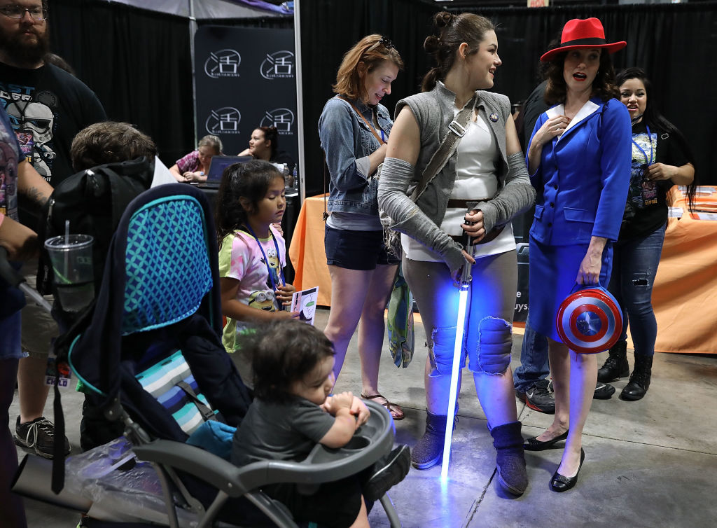 Cosplayers and others wait in line to have a photograph taken with people dressed as Star Wars characters during the first day of Awesome Con at the Walter E. Washington Convention Center June 16, 2017 in Washington, DC. Thousands of fans of popular culture, fantasy and science fiction will gather for the three-day convention that includes comic books, collectibles, toys, games, original art, cosplay and Marvel Comics legend Stan Lee.  (Photo by Chip Somodevilla/Getty Images)